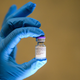 A health care worker in the Uk holding a vial of the Pfizer/BioNTech Covid-19 vaccine.